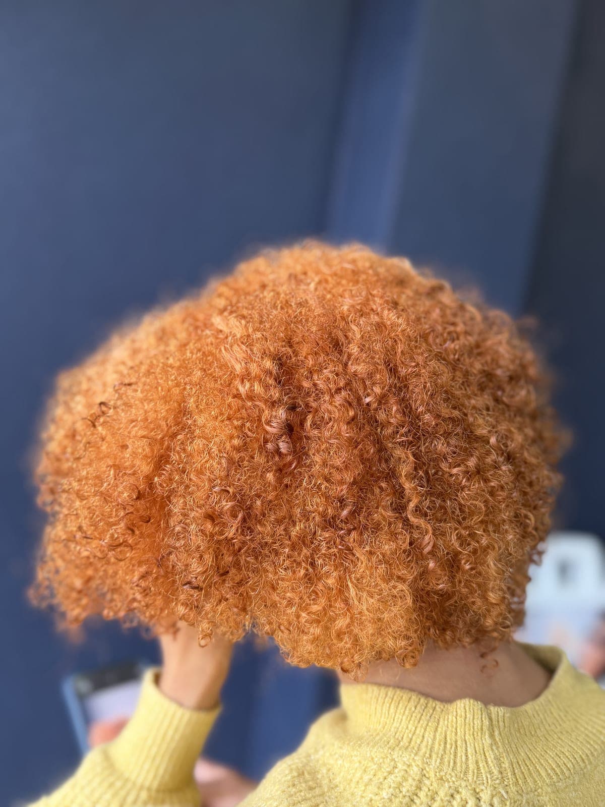 Vivid copper color on a full head of tight natural curls