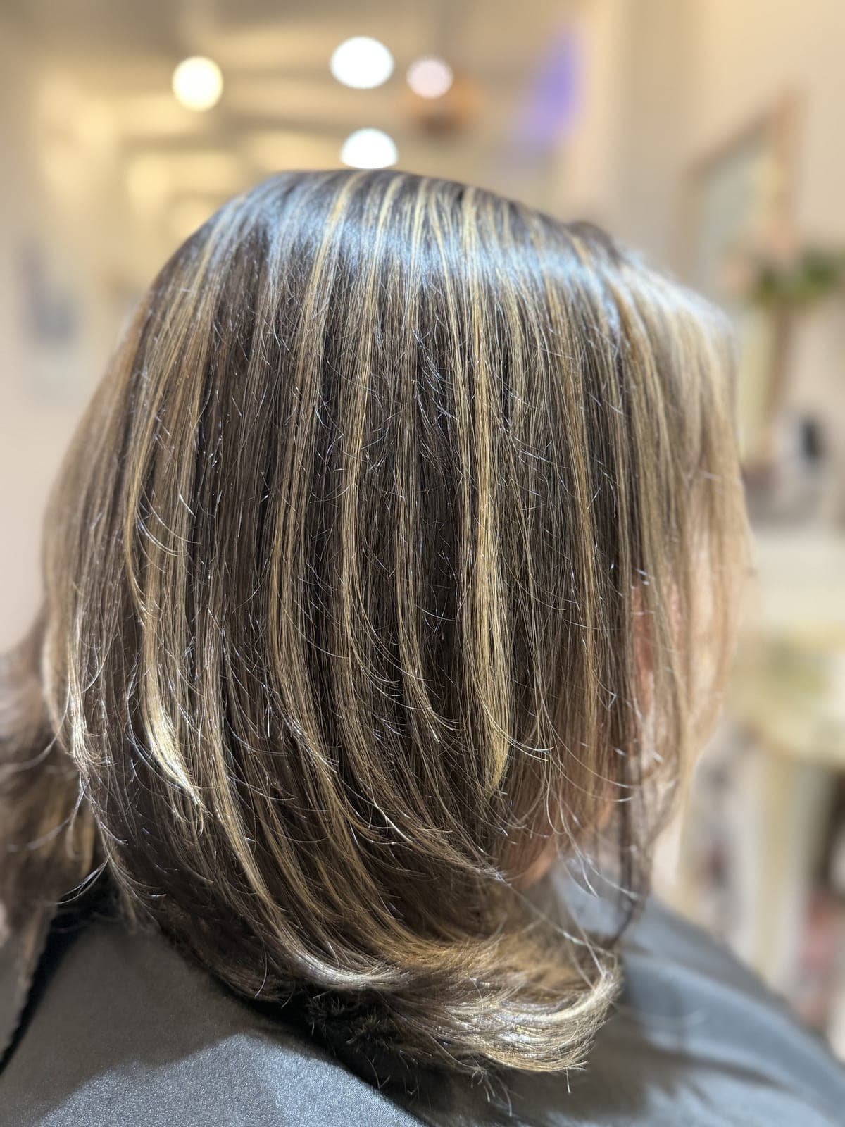 Wavy dark lob with bold platinum ribbons woven through the lengths